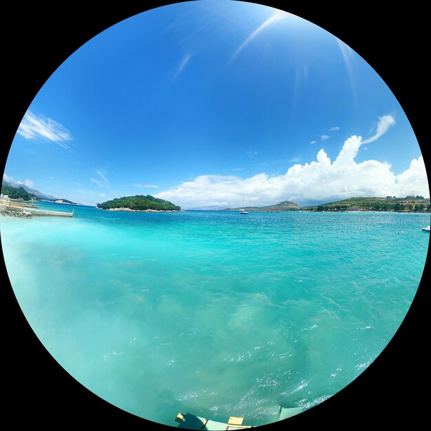 Fish-eye lens of ksamil islands against blue sky on sunny day