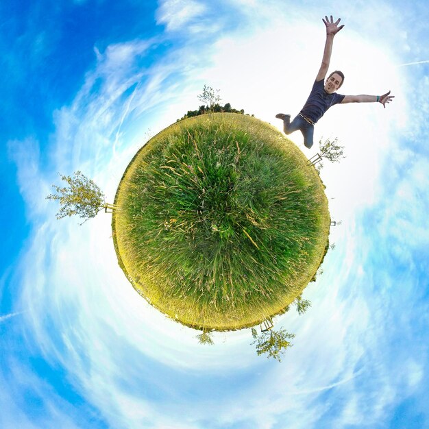 Photo fish-eye view of man jumping on grassy field