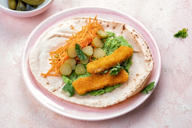 Fish fingers wraps with pea puree