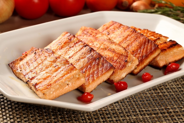 Fish grilled with vegetables in the plate.