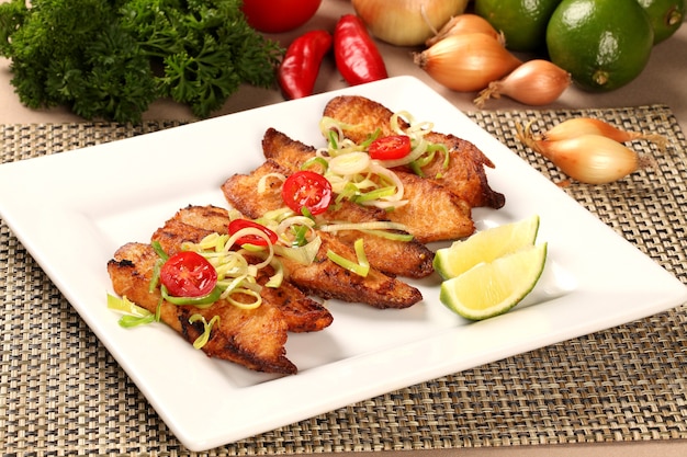 Fish grilled with vegetables in the plate.