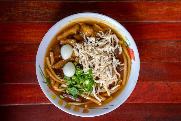 Fish maw soup in a white cup on an old table