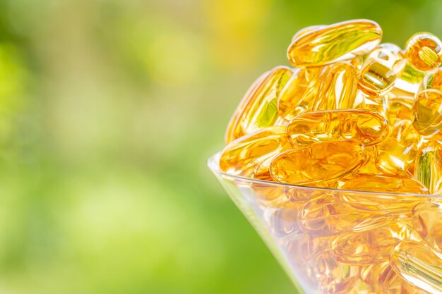 Fish oil capsule in a clean martini glass.