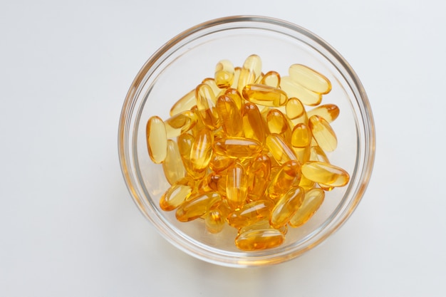 fish oil capsules on glass bowl