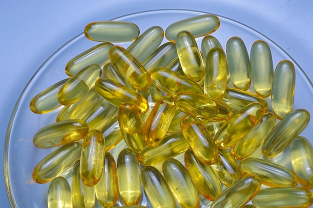 Fish oil capsules on a glass plate