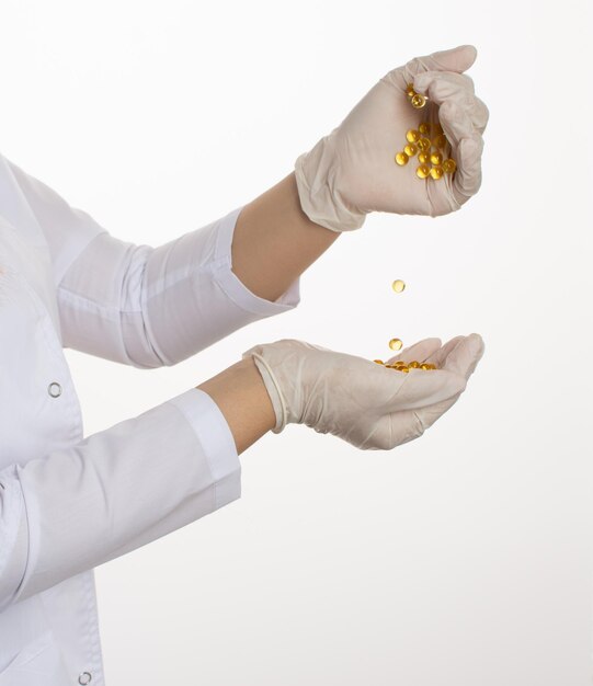 fish oil in capsules hands in medical gloves