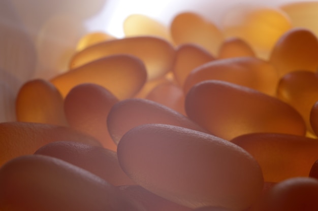 Fish oil capsules illuminated from below. close-up.