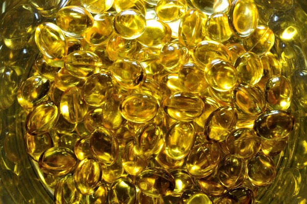 Fish oil capsules illuminated from below. close-up.