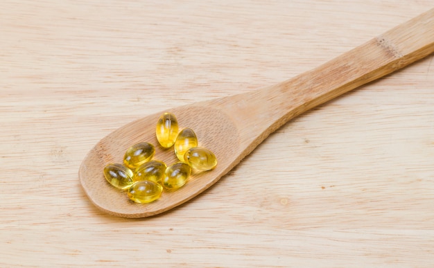 Fish oil capsules in a spoon