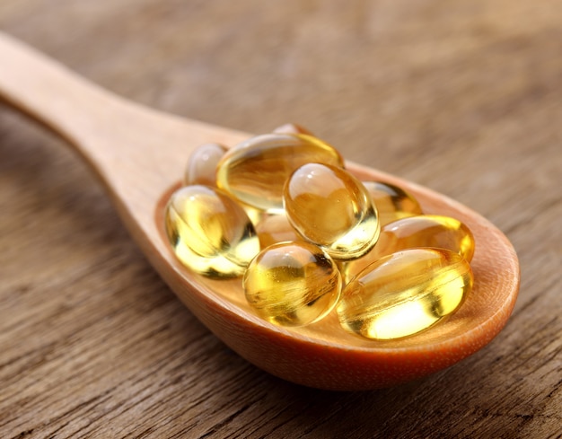 Fish oil capsules in a spoon