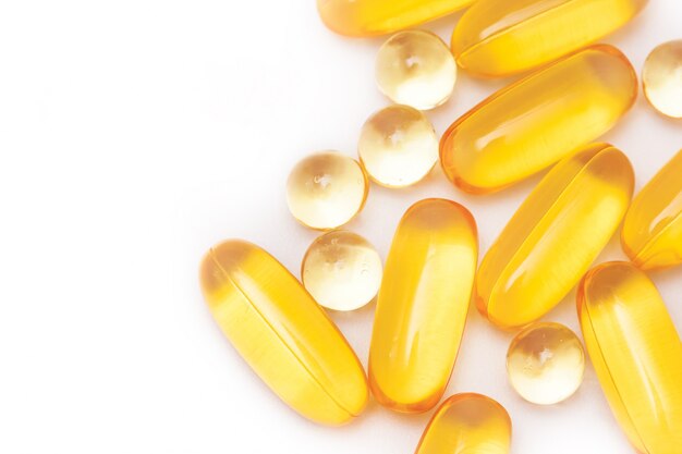 Fish oil capsules on white background