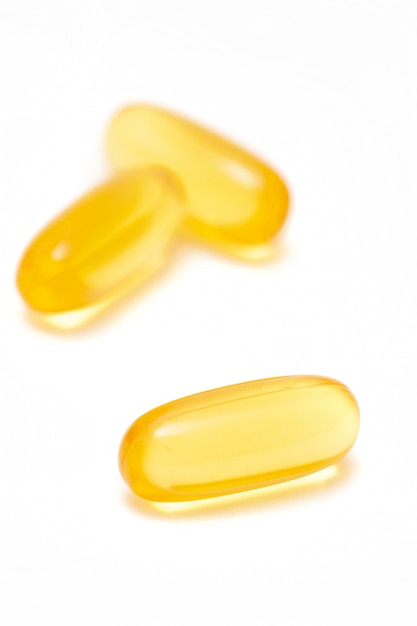 Fish oil capsules on white background