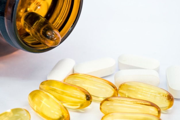 Fish oil capsules with bottle packed on white background