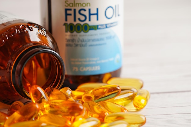 Photo fish oil or cod liver oil gel in capsules with omega 3 vitamins supplementary healthy food