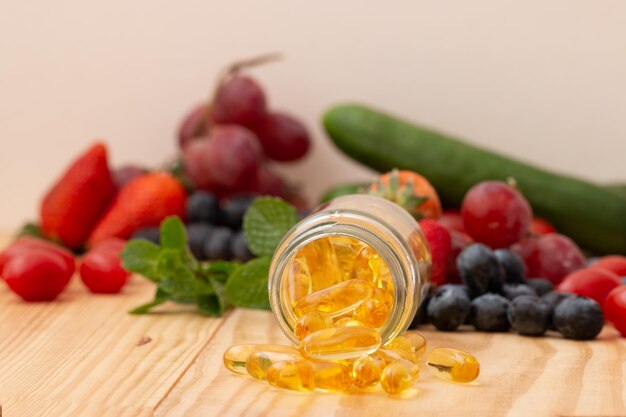 Fish oil omega 3 with vitamin Dcapsules in the glass bottle on wooden table with variety fruits