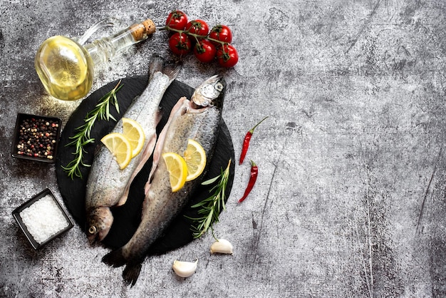 写真 石の背景にレモンとトマトの魚