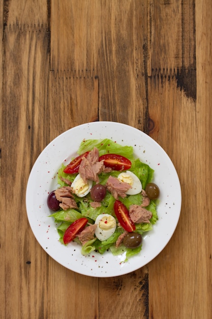 Fish salad on white plate