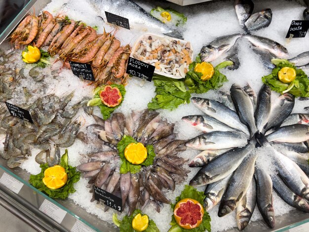 Fish and seafood beautifully arranged in ice on the counter