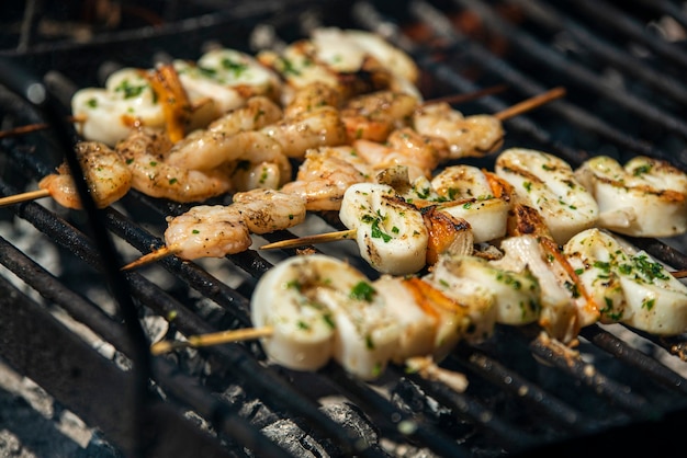 Fish skewers with shrimp and squid on the grill