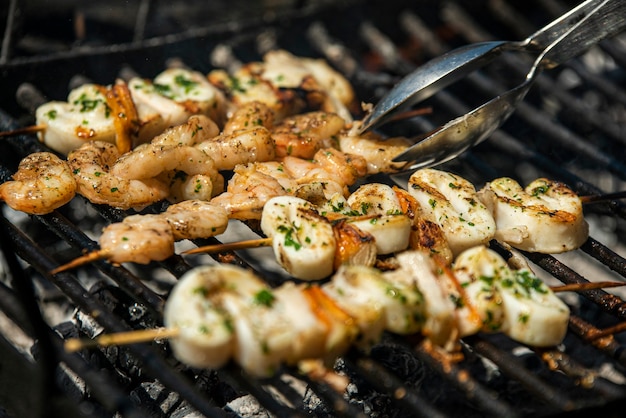 Fish skewers with shrimp and squid on the grill