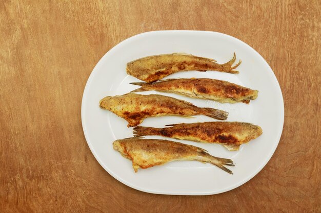 Fish smelt fried in a plate top view fried fish