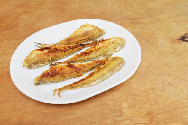 Fish smelt fried in a plate. top view