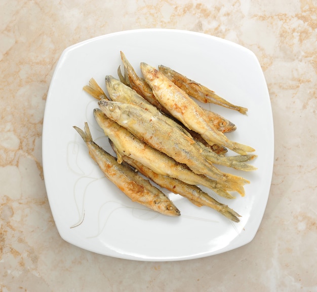 Fish smelt fried in a plate