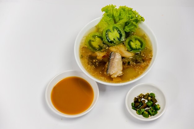 Fish soup in the bowl on the table