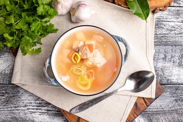 Fish soup fish soup with seafood on a wooden white background