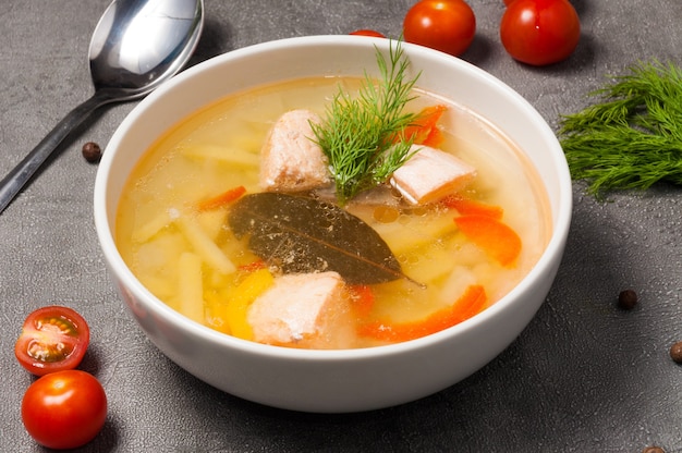 Zuppa di pesce con salmone, patate in una ciotola bianca