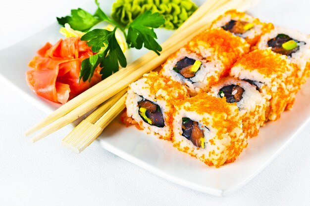 Fish sushi on a plate on a white background