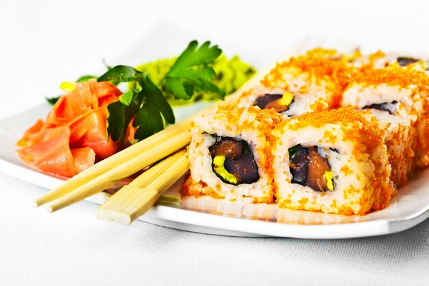 Fish sushi on a plate on a white background