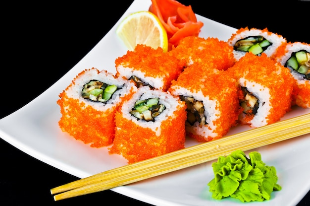 Fish sushi on a plate on a white background