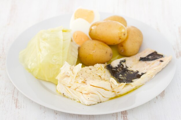 Fish with potato and cabbage on plate