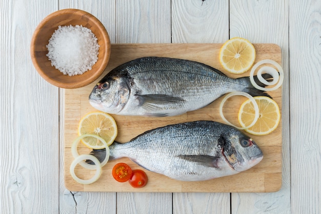 Fish with spices on a wooden background