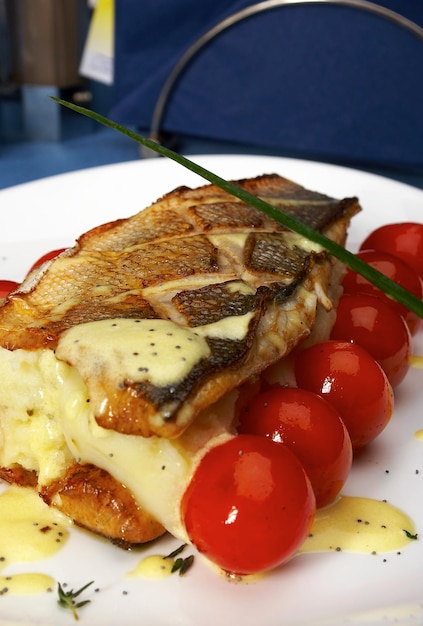 Fish with tomatoes and a potato