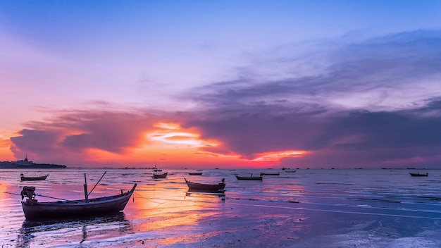 Fisherman boat on the beach at sunset.