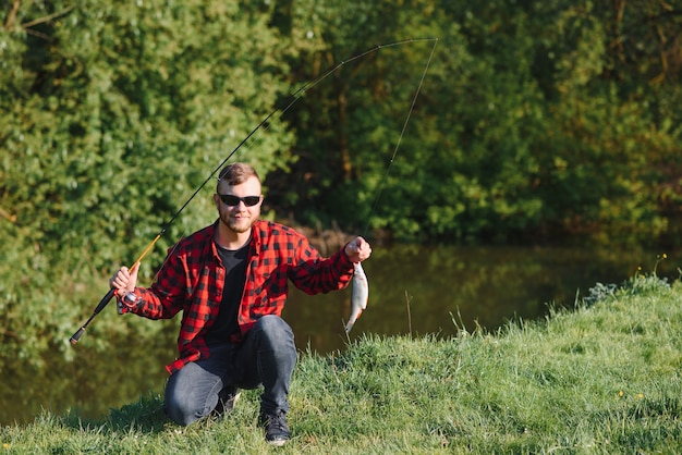 Fisherman by the river with a catch of fish