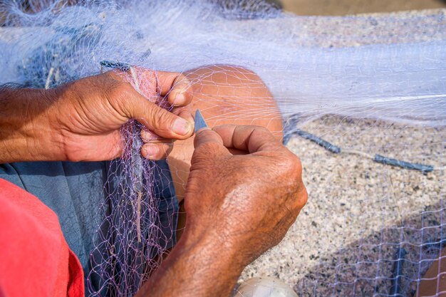 Fisherman casting his net at the sunrise or sunset Traditional fishermen prepare the fishing net Fishermen on beach at the Fishing