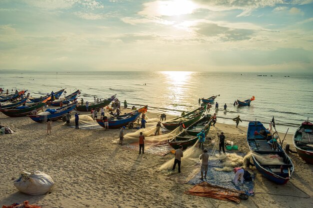 Fisherman casting his net at the sunrise or sunset Traditional fishermen prepare the fishing net