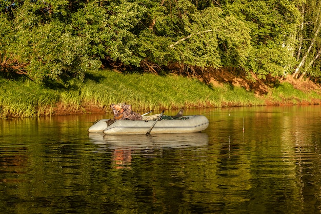 Fisherman catch fish with a rubber boat