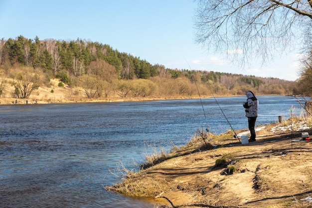 A fisherman fishing with a rod