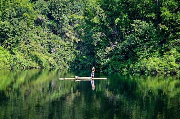 Fisherman in green river