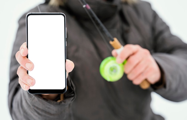 Fisherman holding a blank phone