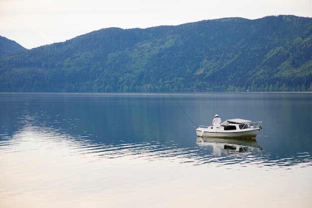 Fisherman on Lake Ossiacher See, lake in carinthia, south of Austria