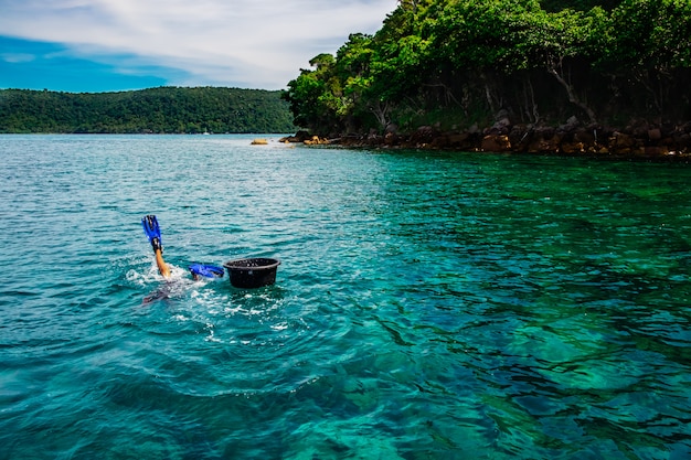 Un pescatore che si immerge facendo snorkeling e tuffandosi nel mare