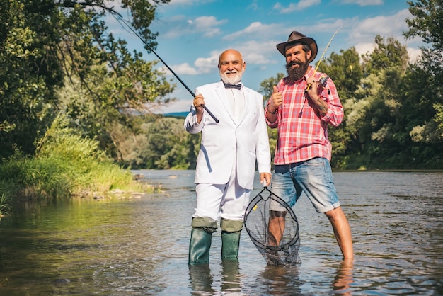 Fisherman and trophy trout fisherman fishing with spinning reel fly fishing for trout fly fisherman