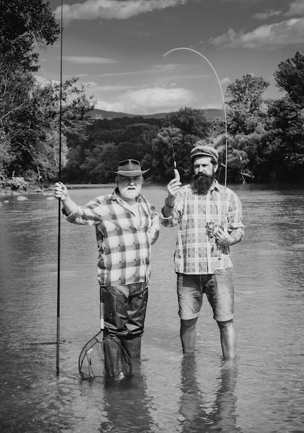 Fisherman and trophy trout young man and old mature man fly fishing difference between fly fishing a