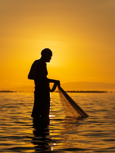 Fisherman use net catch the fish in the sea