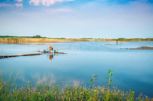 Fisherman with rod on a lake